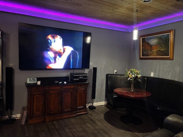 home theater featuring wooden ceiling, a raised ceiling, and hardwood / wood-style flooring