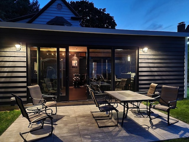 view of patio terrace at dusk