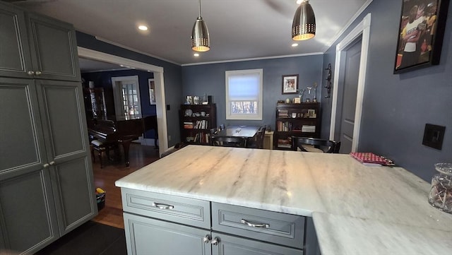 kitchen featuring gray cabinets, ornamental molding, pendant lighting, and a center island