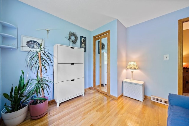 sitting room with light wood-style floors and baseboards