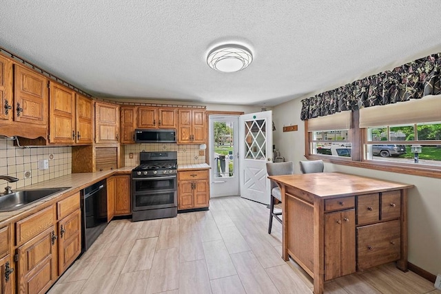 kitchen featuring stainless steel microwave, double oven range, a sink, black dishwasher, and brown cabinets