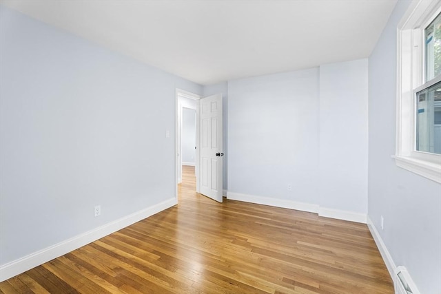 69 Kingman Ave, Revere, MA 02151 - empty room featuring light wood-type flooring and a baseboard heating unit