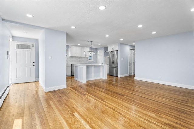 69 Kingman Ave, Revere, MA 02151 - unfurnished living room with recessed lighting and light wood finished floors