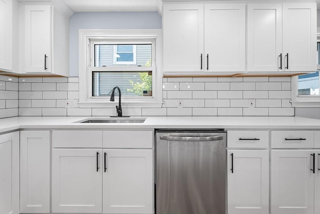 69 Kingman Ave, Revere, MA 02151 - kitchen with stainless steel dishwasher, light countertops, and white cabinetry