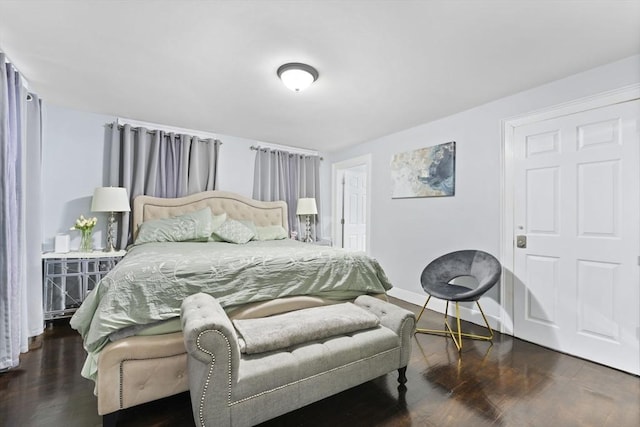 bedroom with dark hardwood / wood-style flooring