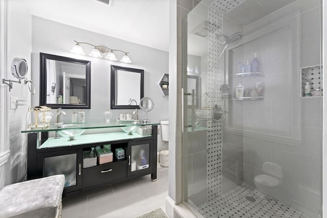 bathroom featuring tile patterned flooring, vanity, and a shower with shower door