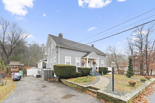 view of front of property featuring a shed and a garage