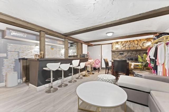 interior space with beamed ceiling and light hardwood / wood-style floors