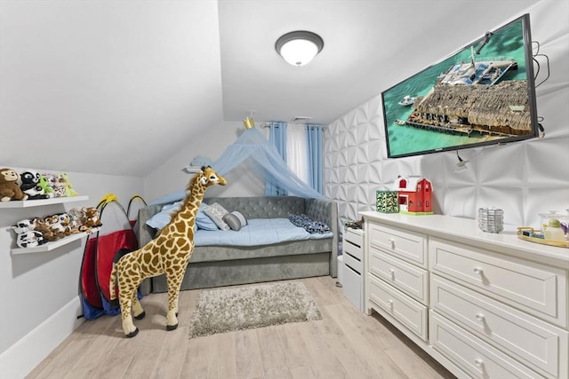 bedroom featuring light hardwood / wood-style floors and vaulted ceiling