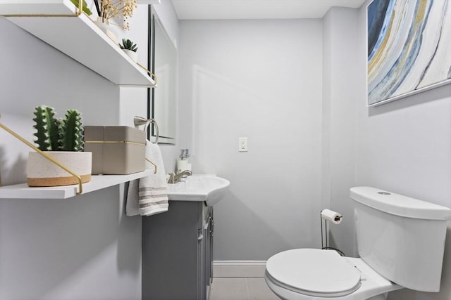 bathroom with tile patterned floors, vanity, and toilet