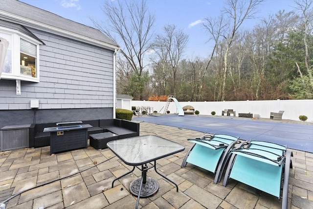 view of patio / terrace with an outdoor living space and a covered pool