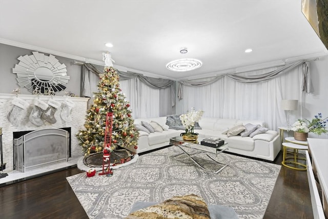 living room with a fireplace, dark hardwood / wood-style floors, and ornamental molding