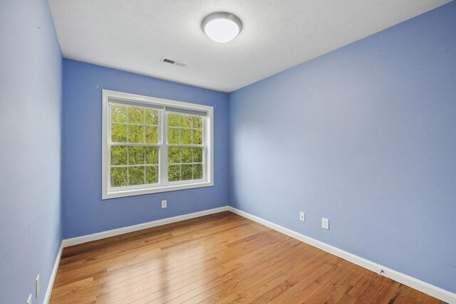 unfurnished room featuring wood finished floors and baseboards