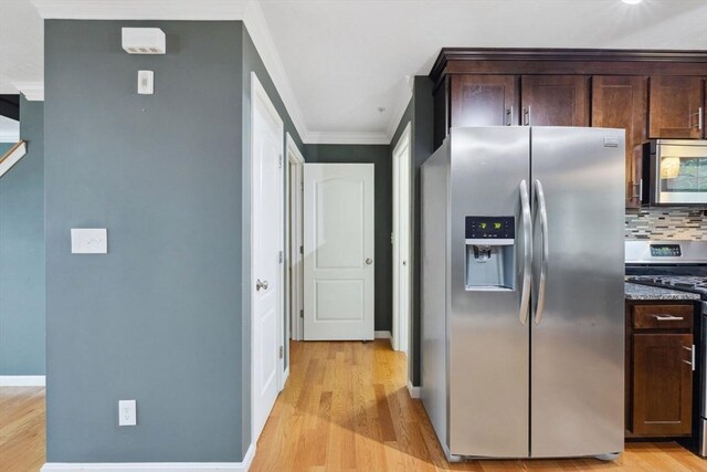 kitchen featuring appliances with stainless steel finishes, crown molding, light wood-style flooring, and dark brown cabinets