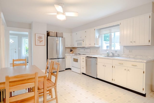 99 Oak St, North Attleboro, MA 02760 - kitchen with appliances with stainless steel finishes, light countertops, a ceiling fan, and white cabinetry