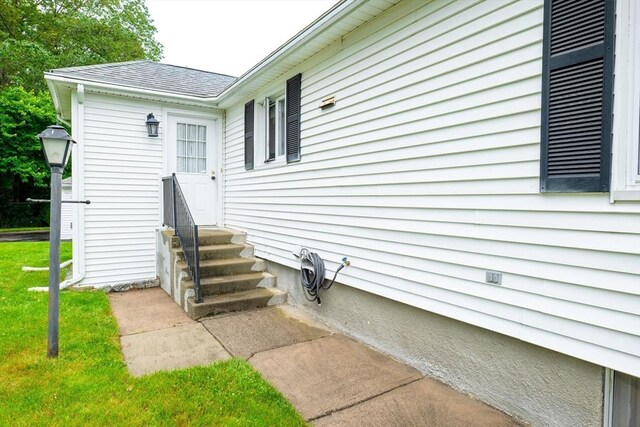 99 Oak St, North Attleboro, MA 02760 - property entrance featuring a lawn and roof with shingles