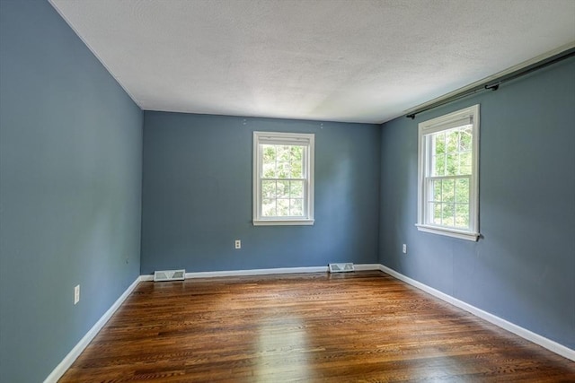 216 Davis St, Northborough, MA 01532 - empty room with wood finished floors and a textured ceiling
