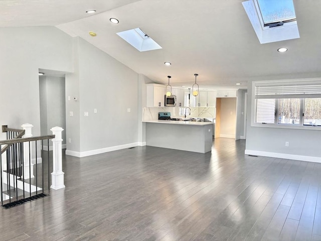 living room featuring lofted ceiling with skylight, baseboards, and dark wood-style flooring