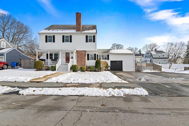 view of front of property featuring a garage and a porch