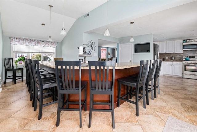 dining area with vaulted ceiling