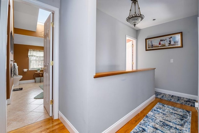 hallway with light hardwood / wood-style flooring