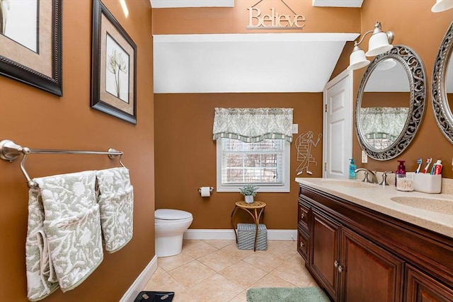 bathroom featuring tile patterned floors, toilet, and vanity