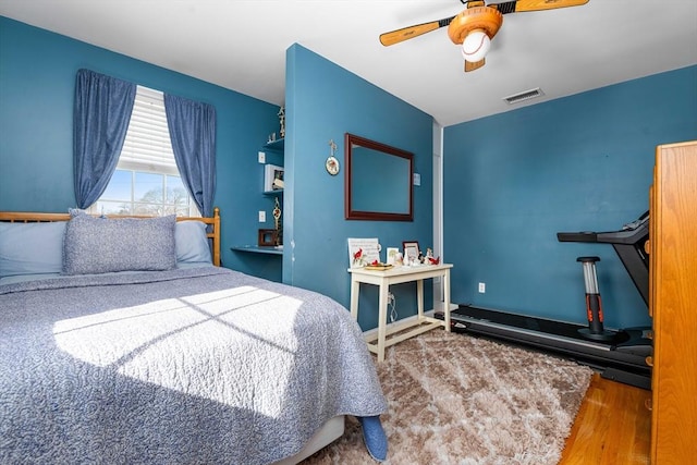 bedroom with wood-type flooring and ceiling fan