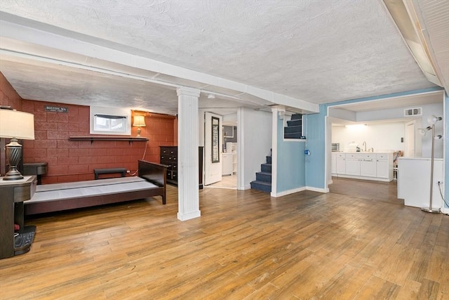 living room with hardwood / wood-style floors and sink