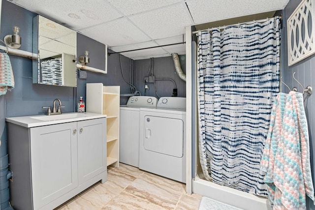 clothes washing area with sink and washer and dryer