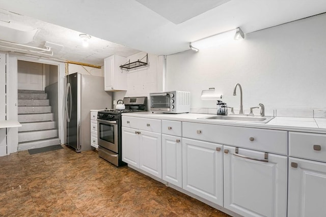 kitchen with white cabinetry, stainless steel appliances, and sink