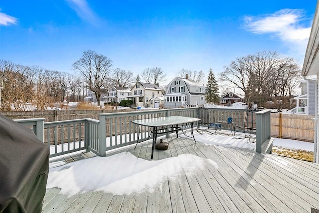 snow covered deck featuring a grill