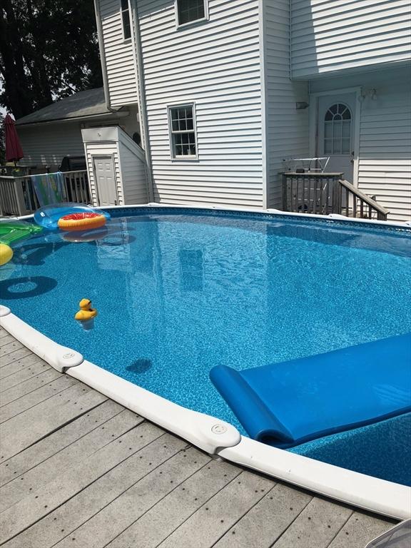 view of swimming pool with a wooden deck