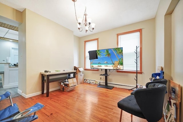 interior space featuring a notable chandelier, baseboards, and wood finished floors