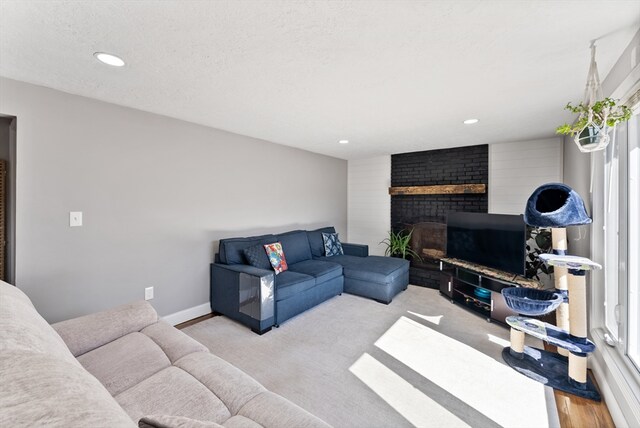 living room with recessed lighting, a fireplace, and baseboards