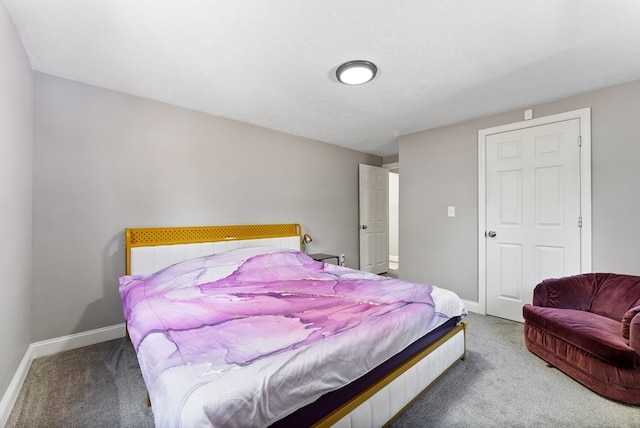 bedroom featuring baseboards and carpet