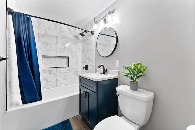 bathroom featuring wood finished floors, toilet, shower / bath combo, and vanity