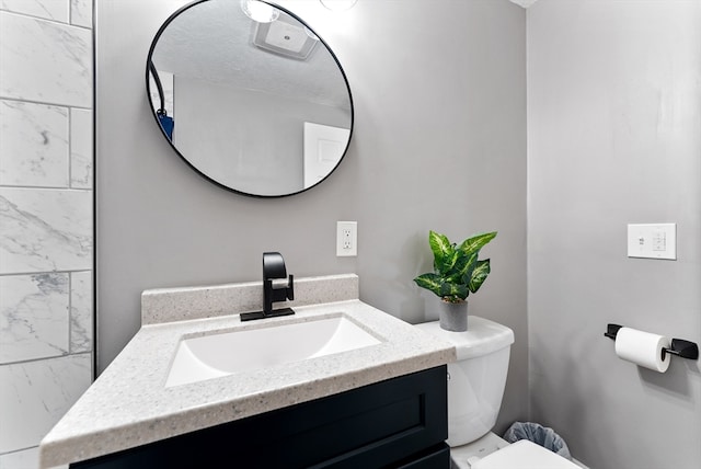 half bathroom featuring toilet and vanity