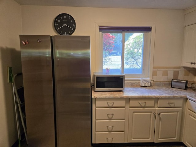 82 Lionel Ave Unit B, Waltham, MA 02452 - kitchen with freestanding refrigerator, white cabinetry, light countertops, and tasteful backsplash