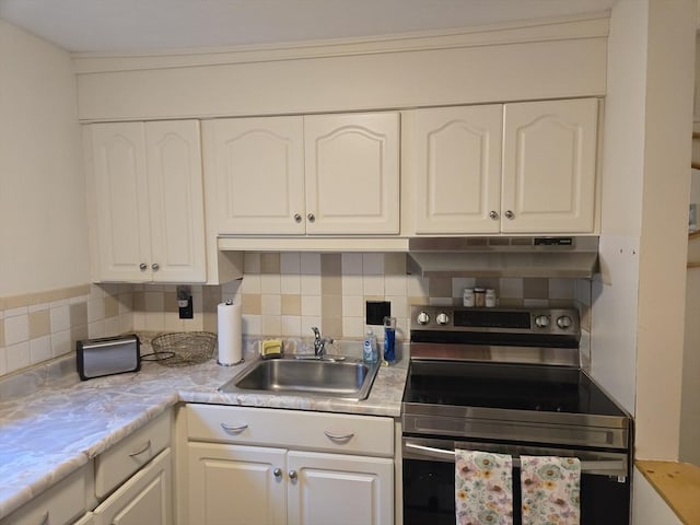 82 Lionel Ave Unit B, Waltham, MA 02452 - kitchen with stainless steel electric stove, under cabinet range hood, a sink, and white cabinetry