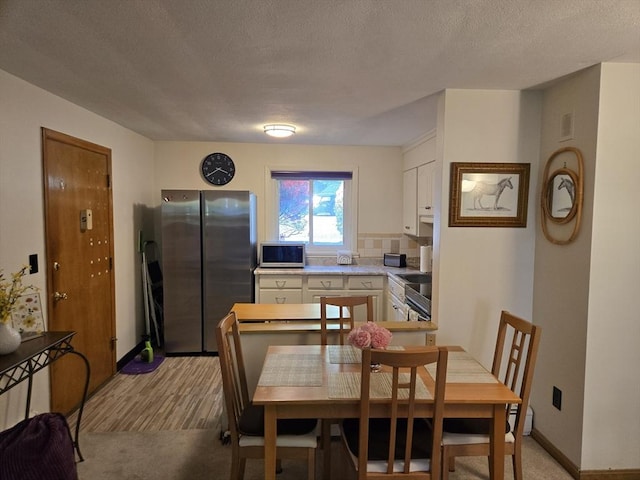 82 Lionel Ave Unit B, Waltham, MA 02452 - dining room featuring light wood-type flooring, a textured ceiling, and baseboards