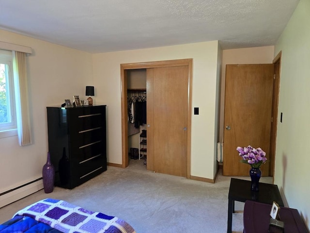 82 Lionel Ave Unit B, Waltham, MA 02452 - carpeted bedroom featuring a baseboard radiator, a closet, and baseboards
