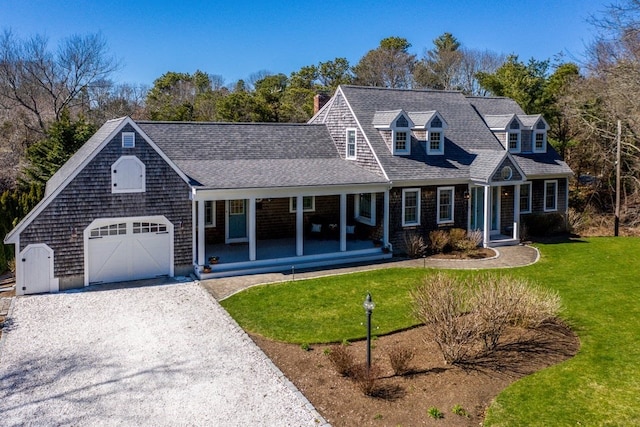 cape cod home featuring a front yard and covered porch