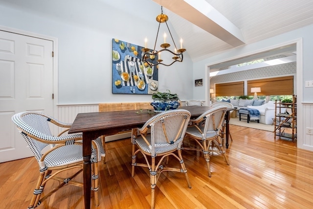 dining area featuring an inviting chandelier and hardwood / wood-style flooring