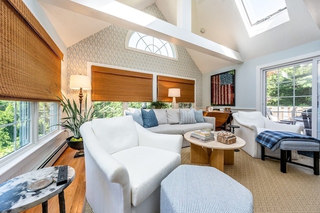 interior space featuring a skylight, hardwood / wood-style flooring, plenty of natural light, and high vaulted ceiling