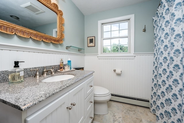 bathroom with vanity, baseboard heating, a textured ceiling, toilet, and a shower with curtain