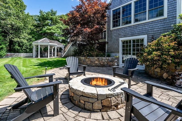 view of patio / terrace featuring a fire pit and a gazebo