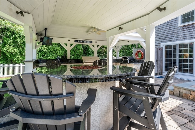 view of patio / terrace with an outdoor bar, grilling area, area for grilling, and ceiling fan