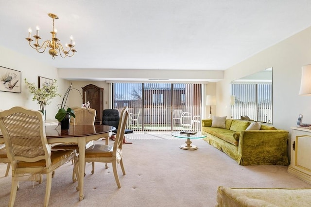 dining room with light colored carpet and an inviting chandelier