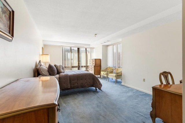 bedroom featuring baseboards and dark colored carpet