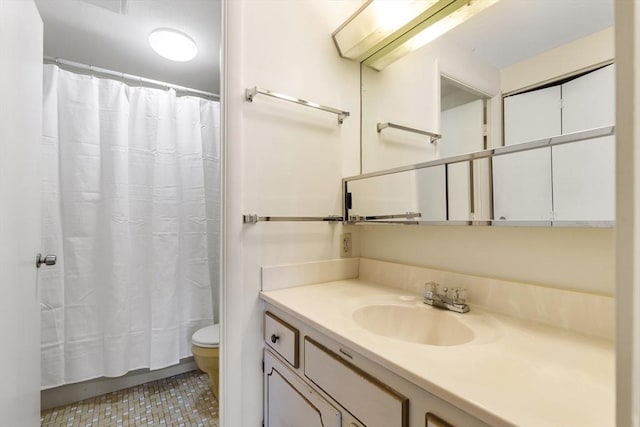 bathroom with tile patterned flooring, toilet, and vanity